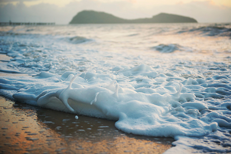 Waves wash over the beach near Cairns, Australia