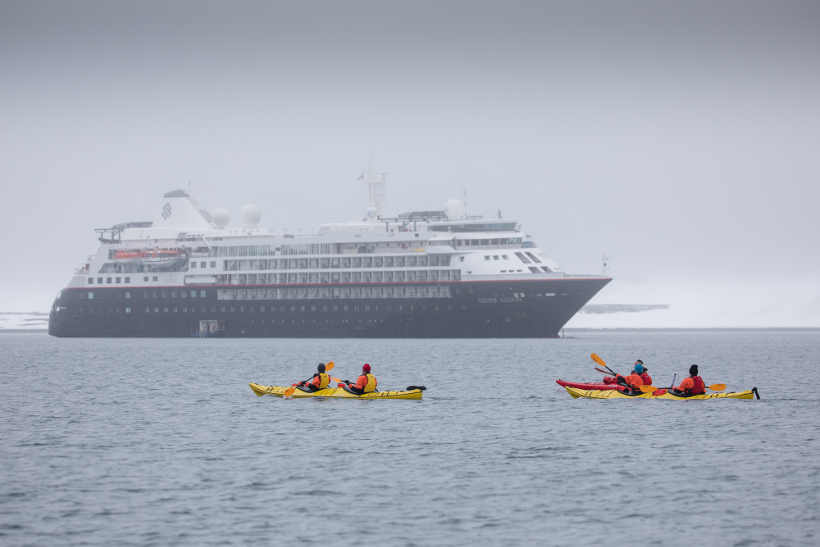 kayaking infront of silver cloud ship antarctica