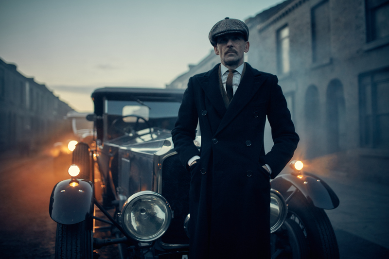 Man in front of old car