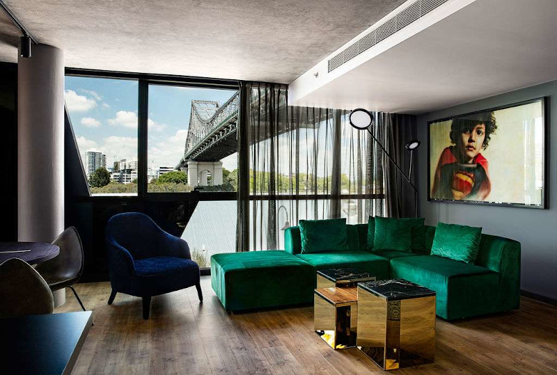 Interior of a room at the fantauzzo. Art work hangs above the bed and the view is of the story bridge and brisbane river