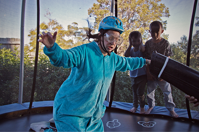 Women on trampoline in backyard