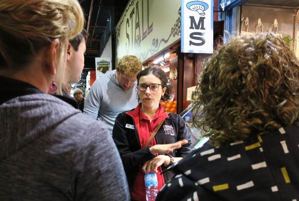 Tour guide gives spiel at Adelaide Central Market mushroom stall