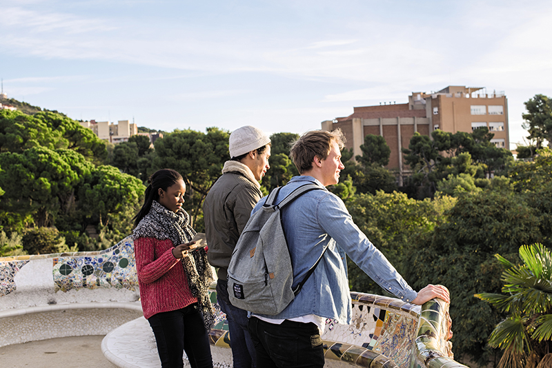 travellers at parc guell lookout in barcelona 