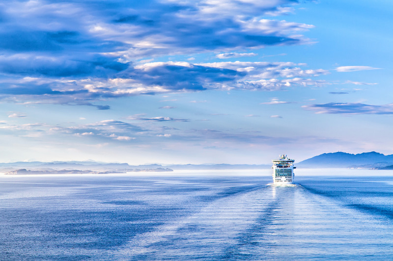 A cruise ship disappears into the distance.