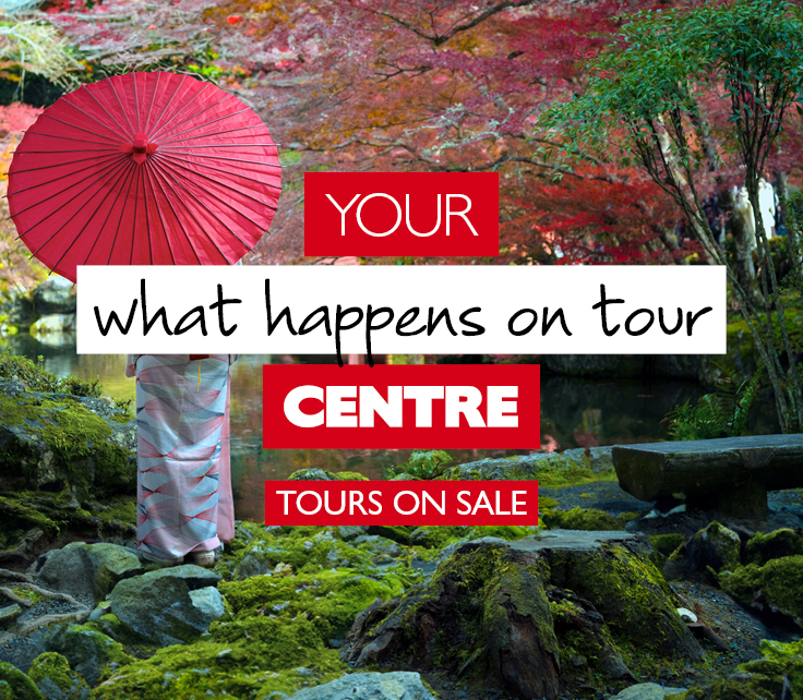 Woman in a relaxing Japanese garden with a red parasol