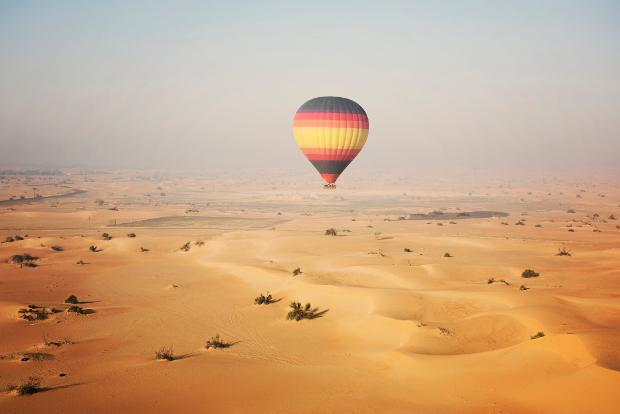 Hot air balloon floating over the Dubai Desert