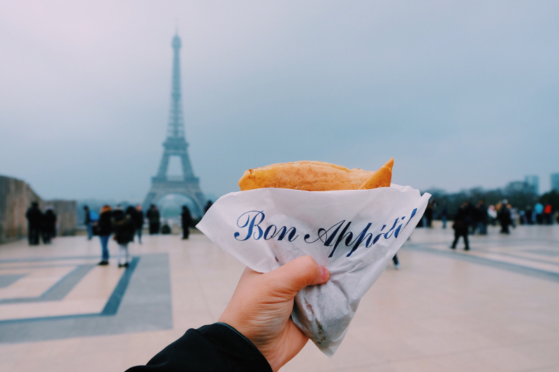 Eating french food near Eiffel Tower.