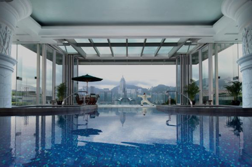 Looking out over city skyline views of Hong Kong from The Peninsula pool.