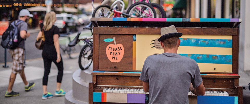 Man playing piano in street, Portland, Oregon