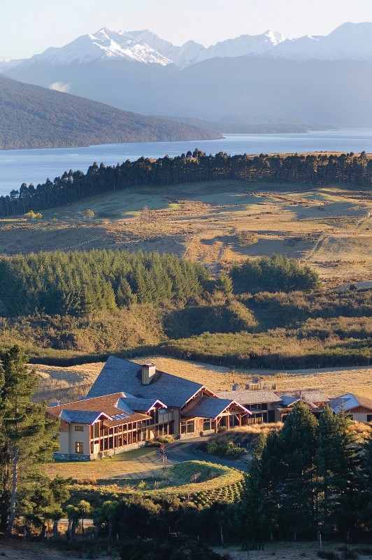 An aerial view of the lodge with mountains in the background