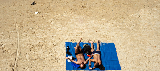 Honeymooning couple relaxing on the beach