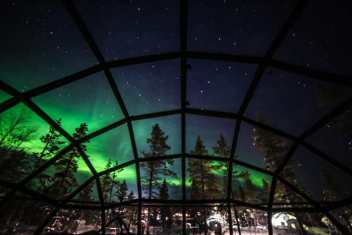 The breathtaking splendour of the aurora borealis seen from a glass Igloos, Saariselka, Finland - 14 Romantic travel experiences for valentines day