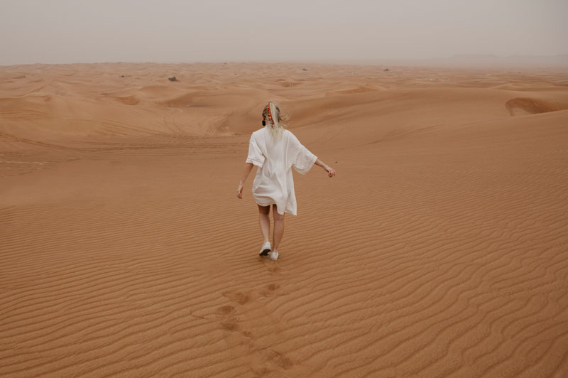 Woman running in desert in Dubai