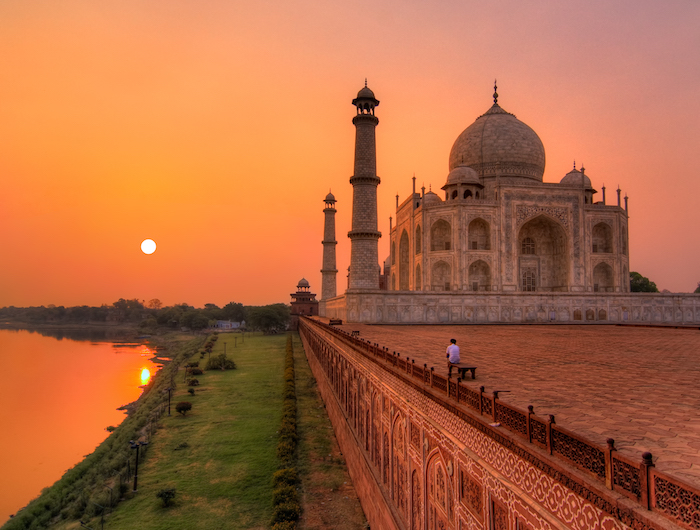 a man watches the sunrise over the taj mahal in Agra - romantic travel experiences for valentines day