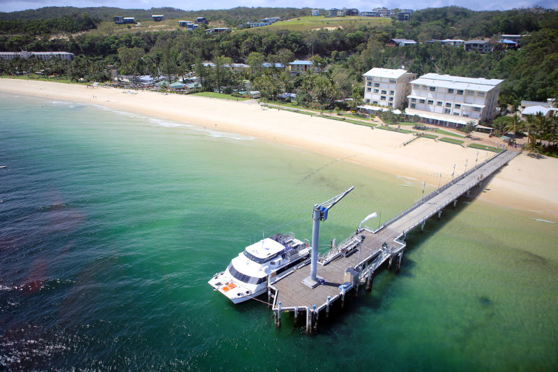 jetty off islnad with boat docked aerial view