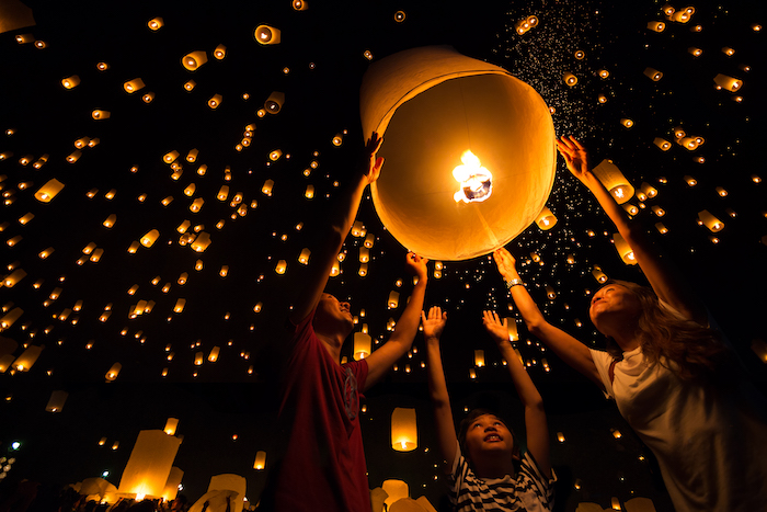 family release lanterns at Yi Ping festival - travel with kids in Thailand