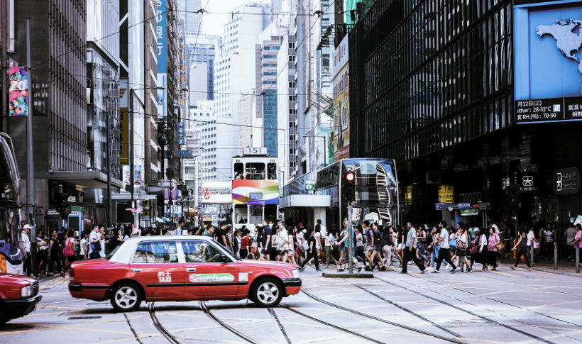 busy hong kong street with taxi in foreground