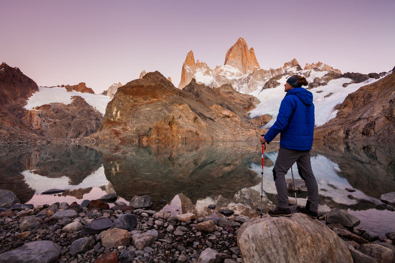 man infront of lake and mount fitz roy patagonia