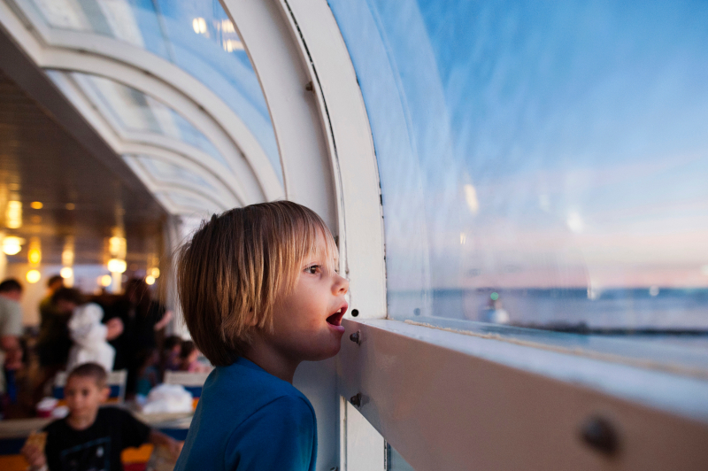 a child looking out the cruise window