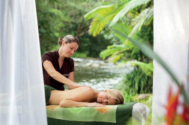 A woman receives a massage at Silky Oaks Lodge & Healing Waters Spa in Mossman, Tropical North Queensland.