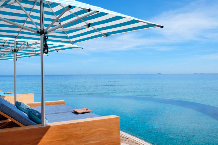 sun loungers by pool and ocean malamala beach resort fiji