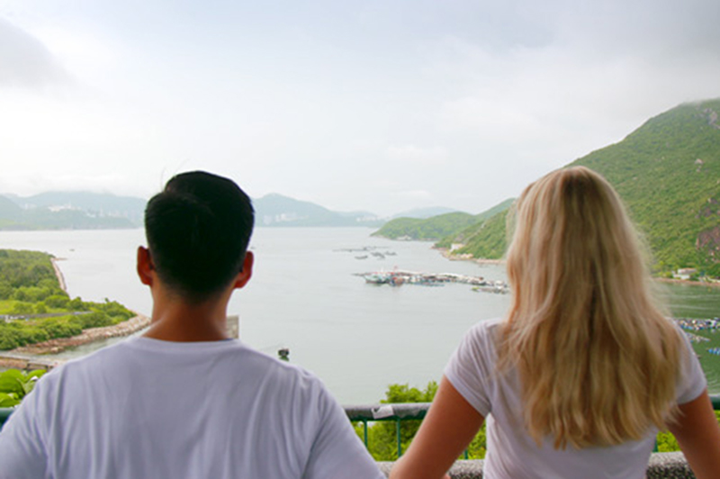Two people admire the view of Lamma Island, Hong Kong.