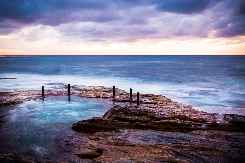 small rockpool with ocean behind