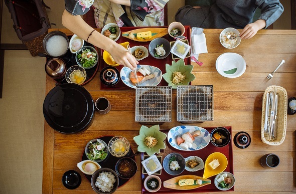 two people eating japanese food from above