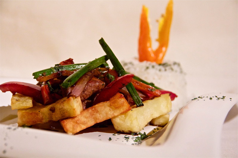 Lomo saltado - beef strips served with hot chips and rice.