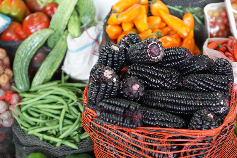 A close-up view of corn, beans and other produce at a market in Lima, Peru.