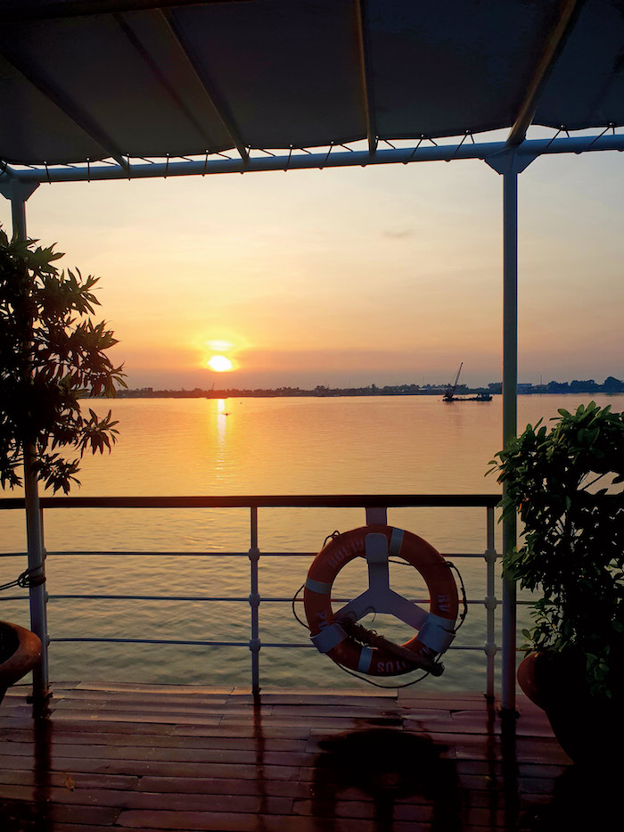 sunset from the deck of an APT river cruise down the mekong river