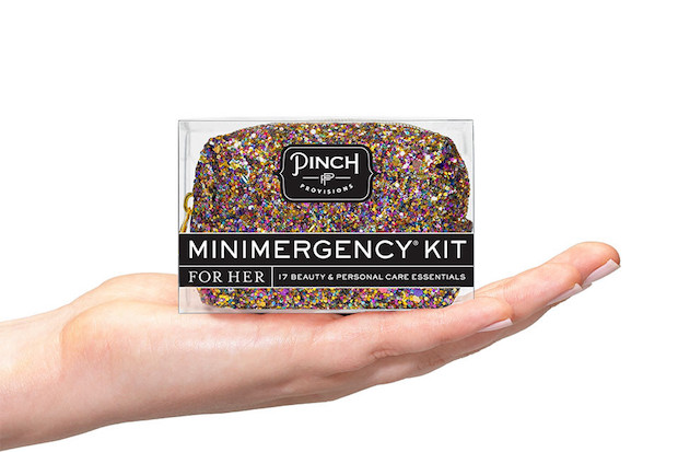 A hand holding one of the minimergency kits
