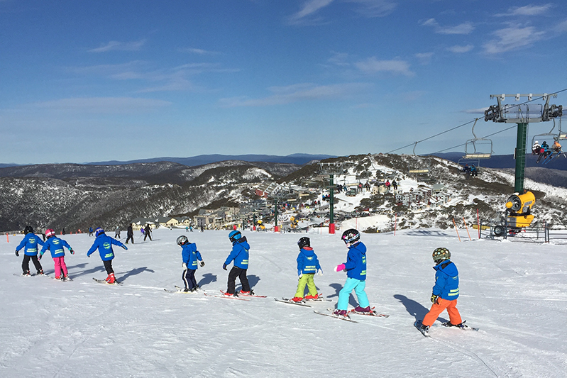 Kids learning to ski on the slopes of Mount Hotham