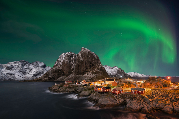 The Northern Lights sparkle over Hamnoy in the Lofoten Islands, Norway