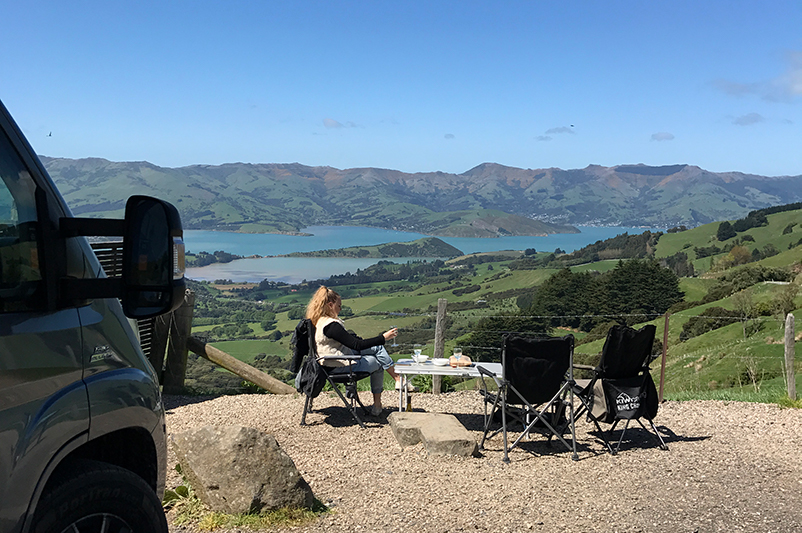 Teen girl sits by the road in New Zealand.
