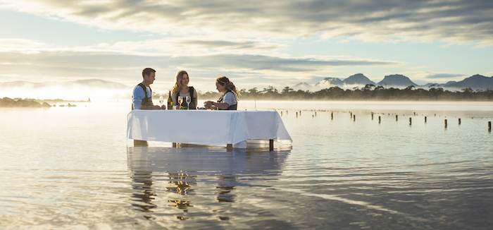 A couple enjoys fresh Pacific oysters and Champagne in a naturally significant wetland on Tasmania's east coast - 14 romantic experiences for valentines day