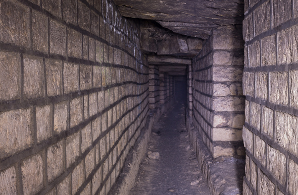 A view down a tunnel of the Paris Catacombs