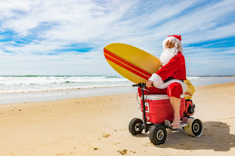 Santa on the beach with a ride-on esky