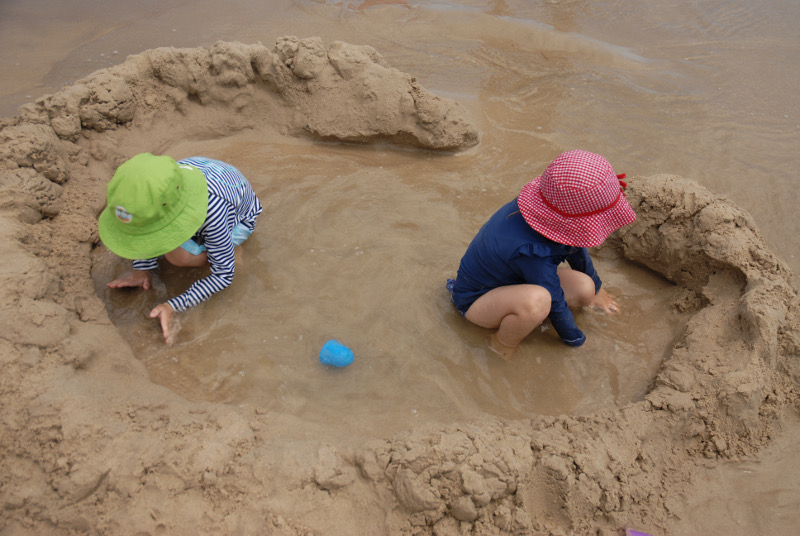two children building a sea fort in iluka, new south wales