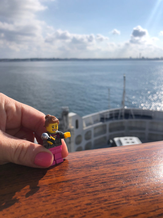 A photo of a lego piece resembling Sheridan. Ocean in background