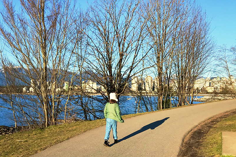 Girl walks along Seawall in Vancouver