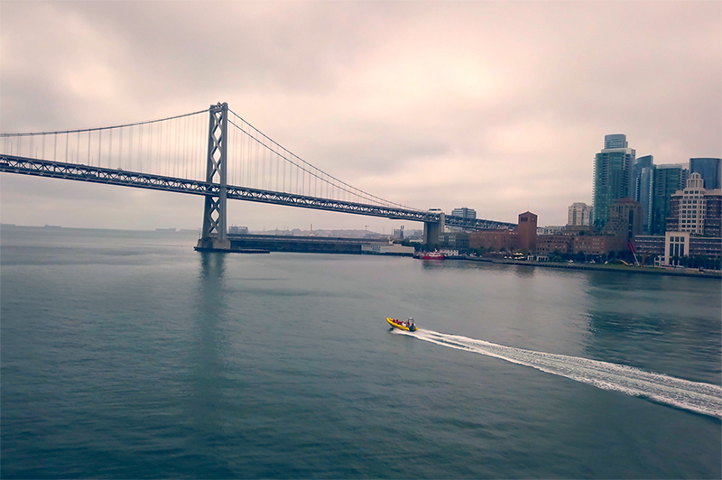 A boat zips along the San Francisco harbour near the Golden Gate Bridge.