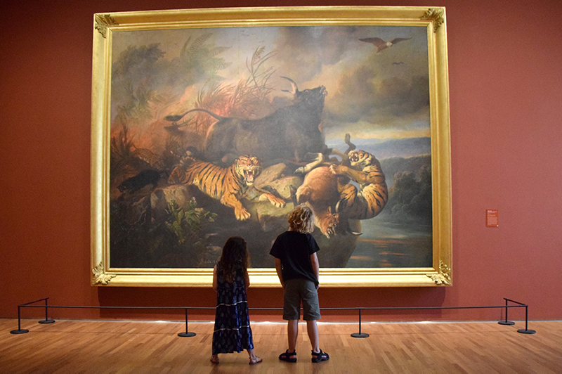 Two children looking at a painting at National Gallery Singapore