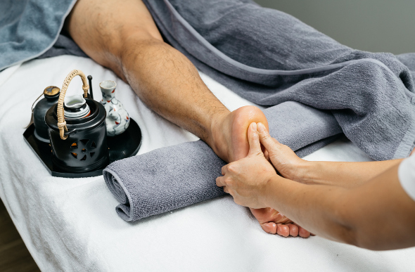 A man receives a foot spa treatment.