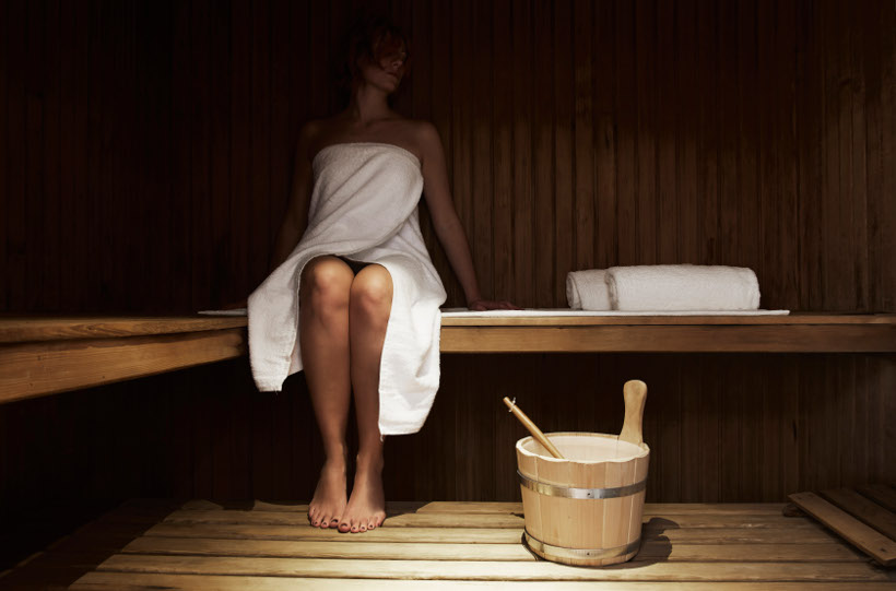 woman in towel in sauna