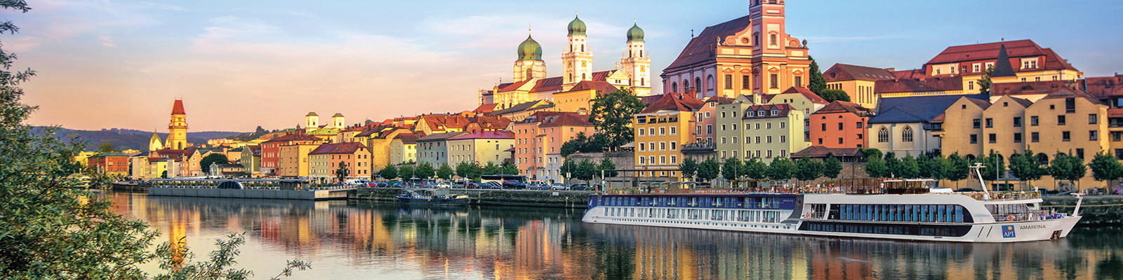 APT river cruise ship docked near Passau, Germany at sunset. 