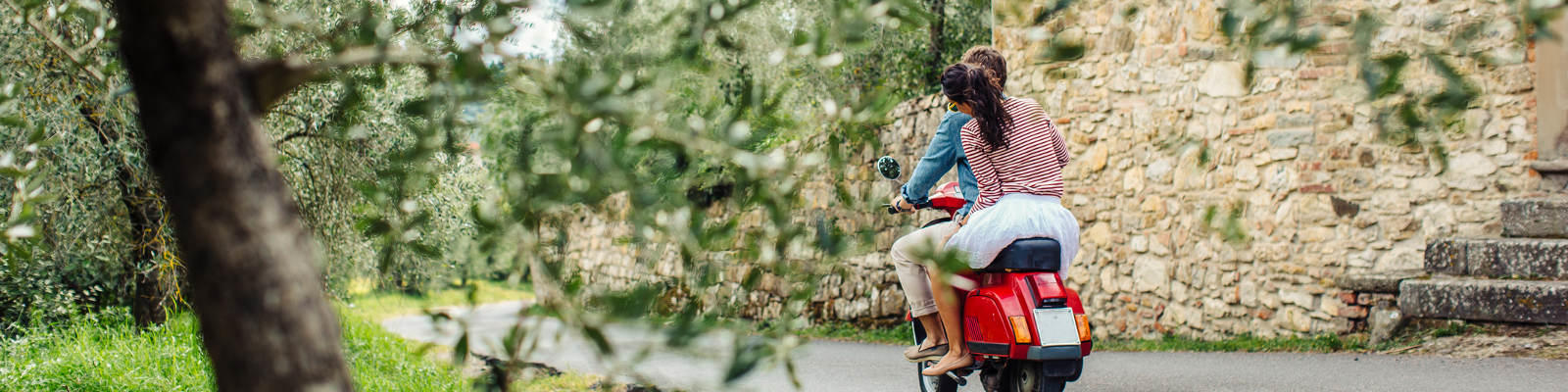 couple on moped in italian countryside