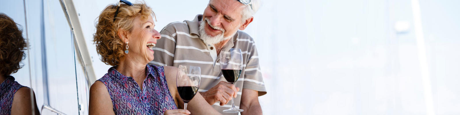 couple drinking red wine on boat