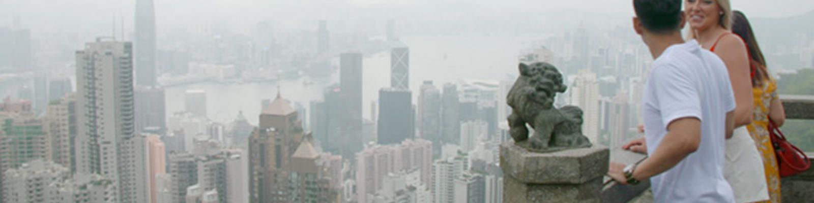 A male and female look at the view from Hong Kong's The Peak.