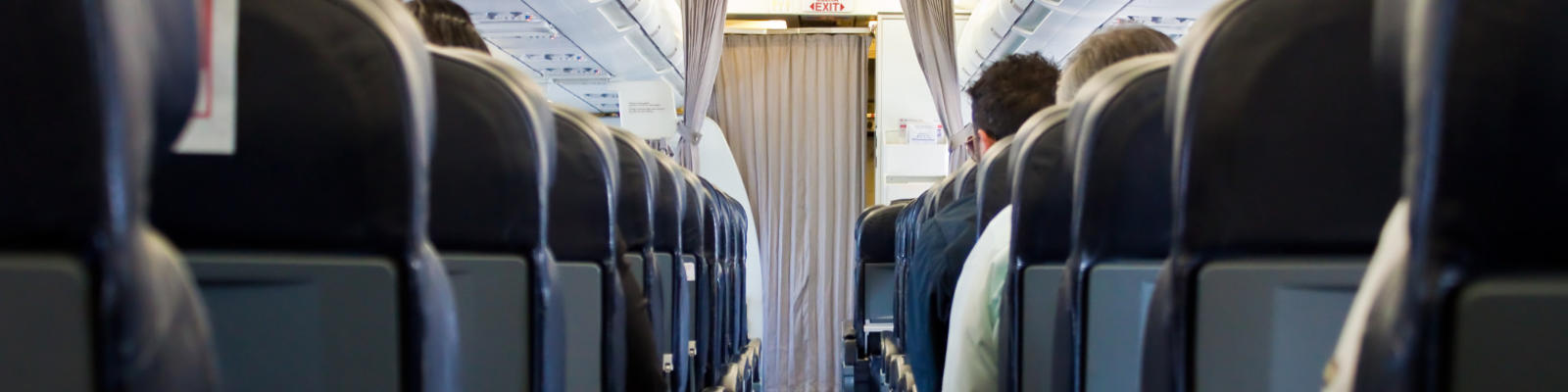 Looking up the aisle of an airplane, going back to front